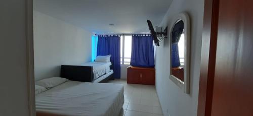 Ένα ή περισσότερα κρεβάτια σε δωμάτιο στο Apartamento en el Laguito Cartagena