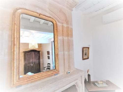 a large mirror on a wall above a sink at Domaine de Gaïa, Piscine, Pétanque, Ping-pong, proche Saint Emilion in Guillac