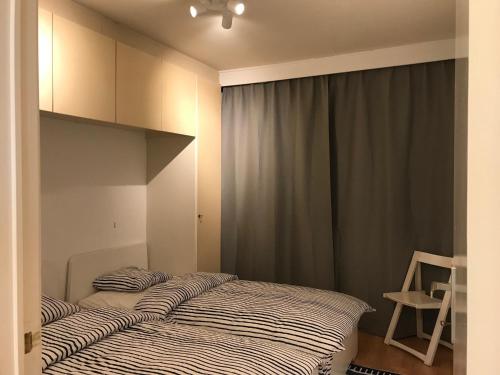 2 camas individuales en un dormitorio con ventana en Gezinsappartement - La Plage - Wenduine zeedijk, en Wenduine
