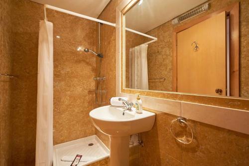 a bathroom with a sink and a mirror and a shower at Lighthouse View in Cascais in Cascais