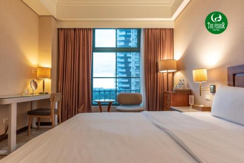 a hotel room with a bed and a large window at The Fisher Hotel in Tamsui