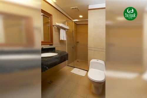 a bathroom with a toilet and a sink and a shower at The Fisher Hotel in Tamsui