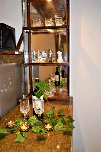 a counter with glasses and bottles of wine on it at Lake Infinity Luxury Condos in Nuwara Eliya