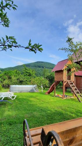 a park with a playground with a slide at "Карпатський краєвид" in Polyana