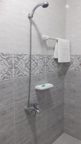 a shower stall in a bathroom with a sink at Dar Al-Jwharah in Duqm