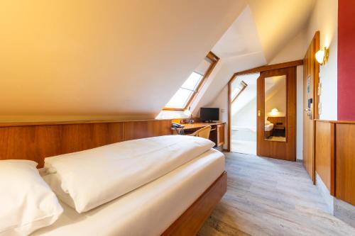 a bedroom with a large bed and a window at AAAA Hotelwelt KÜBLER in Karlsruhe