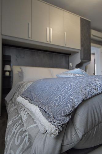 a bedroom with a bed with a headboard at A Casa di Lalla in Bracciano