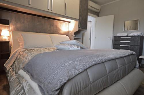 a bedroom with a large bed with a large headboard at A Casa di Lalla in Bracciano
