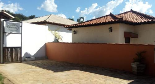 a house with a fence in front of it at Pousada Bruluka in Tiradentes