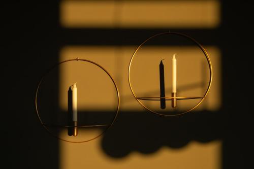 two candles are lit in front of a window at Dreams Hotel Città Studi in Milan