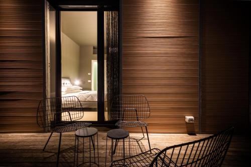 two chairs and a table in a room with a bed at Dreams Hotel Città Studi in Milan