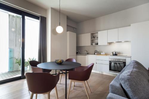 a kitchen and living room with a table and chairs at Dreams Hotel Città Studi in Milan
