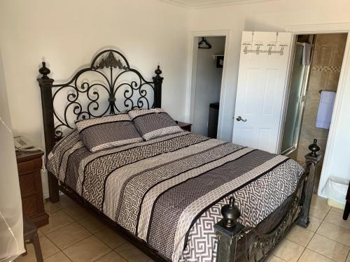 - une chambre avec un grand lit et une tête de lit en bois dans l'établissement Motel Ritz, à Gatineau