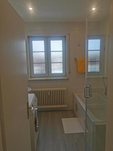 a bathroom with a tub and a sink and a window at Schwarzwaldmarie Ferienwohnung in Löffingen