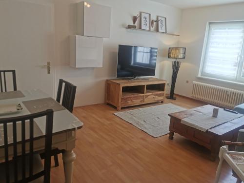 a living room with a flat screen tv and a table at Schwarzwaldmarie Ferienwohnung in Löffingen