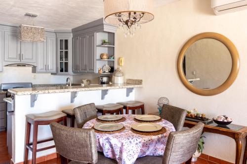a kitchen with a table with chairs and a mirror at Mexican Ambience Townhome with Pool #2 in Puerto Peñasco
