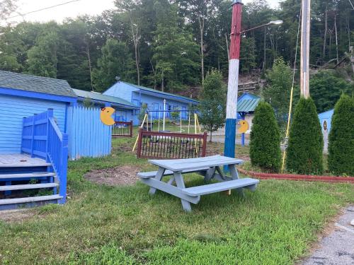 a picnic table in front of a playground at Hillside Motel in Lake George