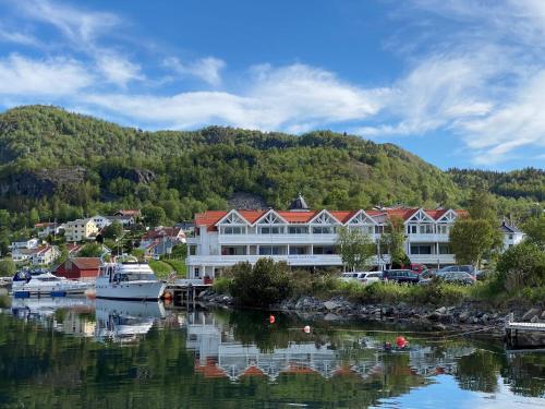 a harbor with boats in a body of water at Sunde Fjord Hotel, free and easy parking in Solavagen