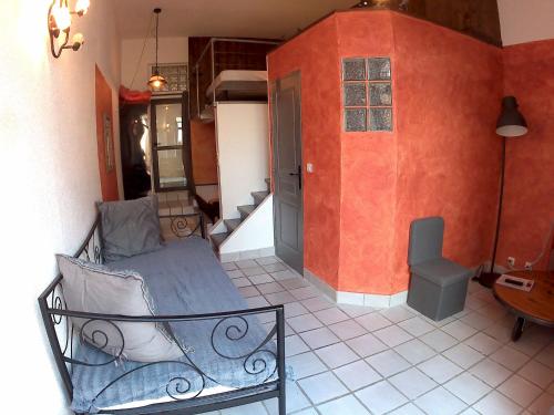 a room with a bed in a room with red walls at Mas d'Asvin & Spa in Saint-Christol-lès-Alès
