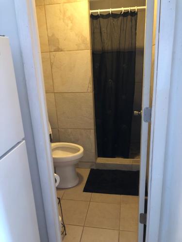 a bathroom with a toilet and a black shower at Hillside Motel in Lake George