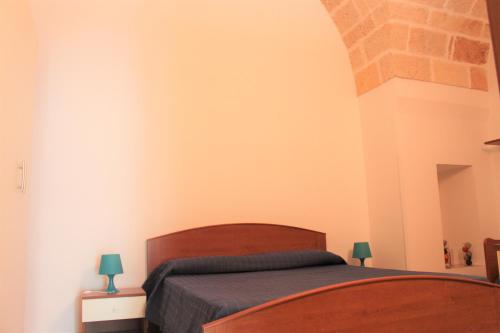 a bedroom with a bed and two lamps on tables at Dimora Nonna Sisina in Polignano a Mare