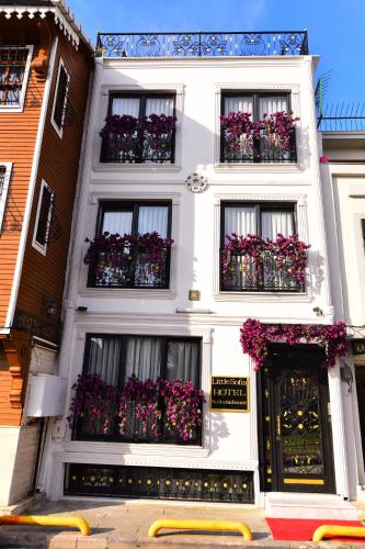 a white building with flowers in the windows at Little sofia hotel in Istanbul