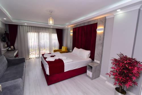a hotel room with a bed and a couch at Little sofia hotel in Istanbul