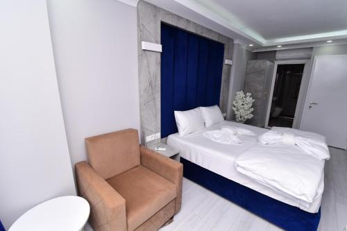a bedroom with a bed and a chair at Little sofia hotel in Istanbul
