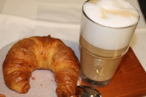 a pastry and a glass of milk and a drink at Trip Inn Hotel Zum Riesen Hanau in Hanau am Main