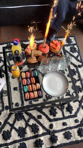 a table with candles and donuts on a rug at Appartement vue port et accès direct mer, centre ville de la Grande Motte prés de Montpellier in La Grande-Motte