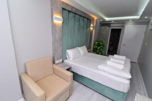 a small bedroom with a bed and a chair at Little sofia hotel in Istanbul