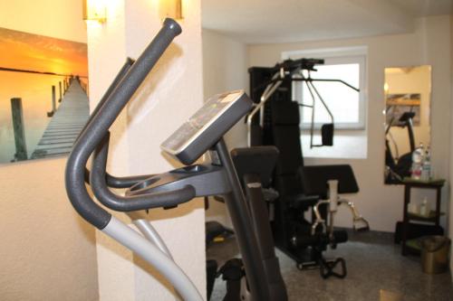 a room with a gym with a treadmill at Trip Inn Hotel Zum Riesen Hanau in Hanau am Main