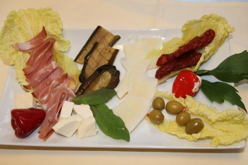 a white plate with different types of meats and cheese at Trip Inn Hotel Zum Riesen Hanau in Hanau am Main