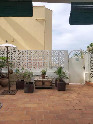 a patio with potted plants and a fence at Casa Alejandro Las Vistas in Arona