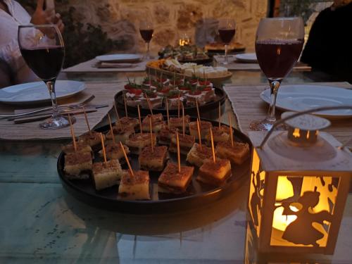 a table with a tray of food and glasses of wine at La Casa Carina in Antalya