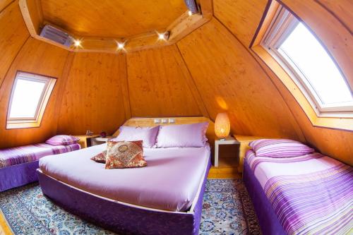 a bedroom with two beds in a small room at DalaiLama Village in Antey-Saint-André
