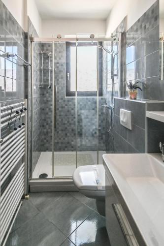 a bathroom with a shower and a toilet and a sink at Apartments Sunčica in Mali Lošinj