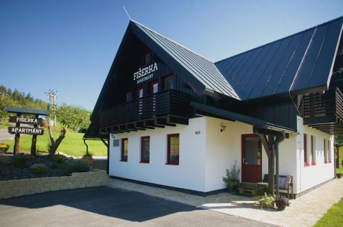 a building with solar panels on the roof at Apartmány Fišerka in Rokytnice nad Jizerou