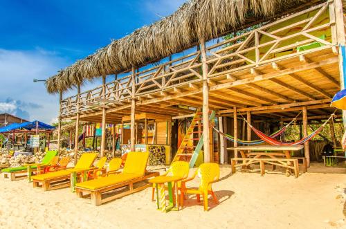 a group of chairs and hammocks on a beach at Nuestros Tres Tesoros II in Playa Blanca