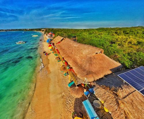 an overhead view of a beach with umbrellas and the ocean at Nuestros Tres Tesoros II in Playa Blanca