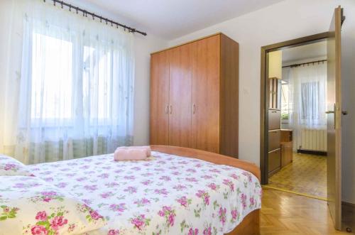 a bedroom with a large bed and a mirror at Apartment in Rovinj/Istrien 11533 in Rovinj