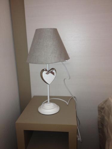 a table with a heart shaped lamp on it at Hotel Lucerna in Castiglione della Pescaia