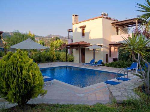 a villa with a swimming pool and a house at Eligia Villas in Mixórrouma