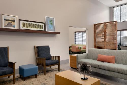 a living room with a couch and two chairs at Country Inn & Suites by Radisson, London, KY in London
