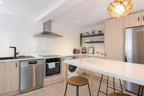 a kitchen with a counter and a sink and a stove at The Little Blue Penguin in Tauranga