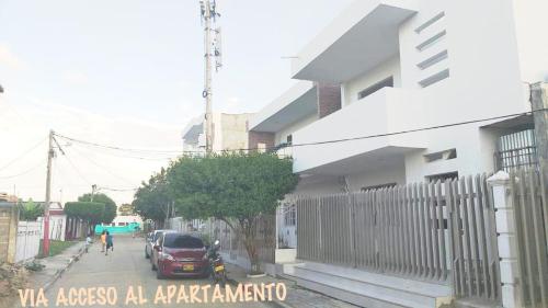 a street with a car parked next to a house at Apartamentos LUISA in Coveñas