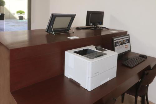 a desk with a computer and a printer on it at Holiday Inn Express Mexico Aeropuerto by IHG in Mexico City