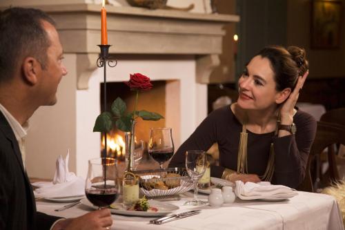 a man and a woman sitting at a table at Schloss Hotel Dresden Pillnitz in Dresden