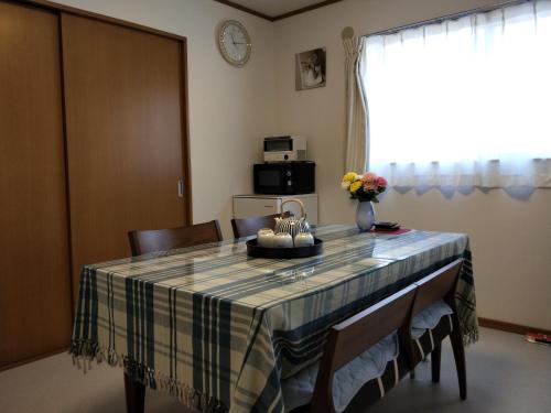 a dining room table with a checkered table cloth at Izu Shirada Villa 伊豆白田家 in Higashiizu