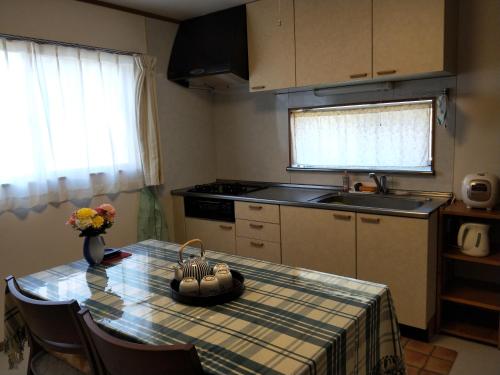 a kitchen with a table with a bowl on top of it at Izu Shirada Villa 伊豆白田家 in Higashiizu